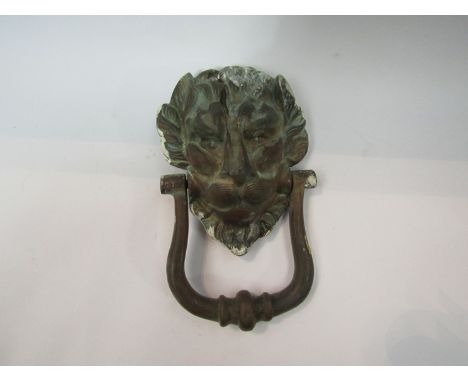 A 19th Century brass lion's mask door knocker, 21cm tall