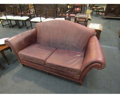 A brown leather two seater sofa