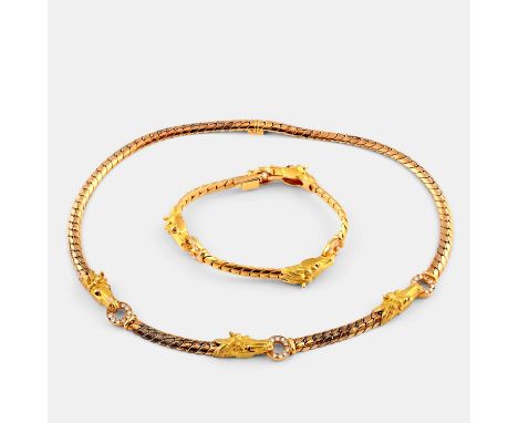 the 18ct gold snake link necklace mounted with three gold horse heads, with ruby eyes and each holding a ring of circular-cut