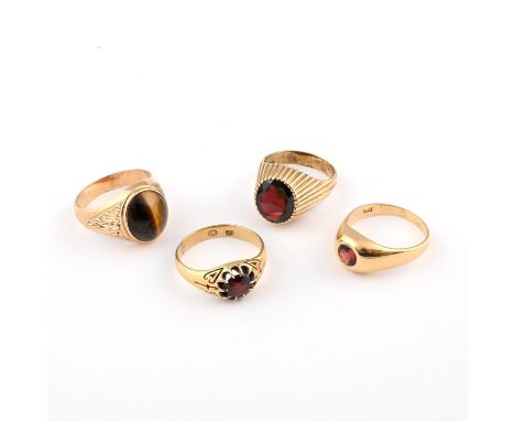 the oval-shaped tiger's eye is set in 9ct gold, 8.4 grams, size T, together with an oval-shaped garnet and 9ct gold ring, 6.8