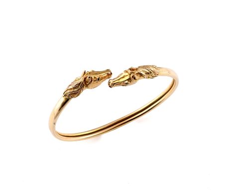 formed with two horse heads realistically formed, 18.6 grams. ** Some wear to the bangle, it is slightly misshapen.
