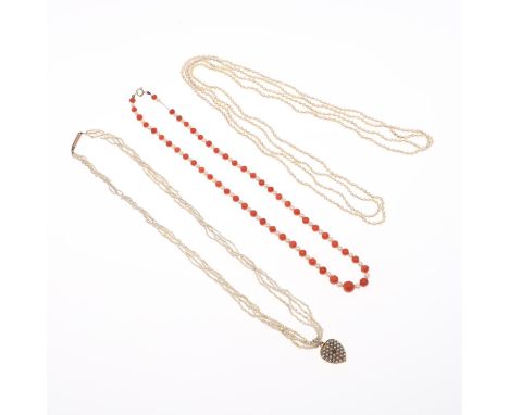 centred with a circular-cut ruby and overall with small pearls, on a four row seed pearl necklace, 43cm long, together with a