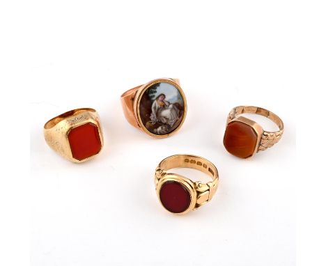 the oval-shaped cornelian is mounted in 18ct gold with fleur de lys decoration to the shoulders, 9.7 grams, size N 1/2, toget