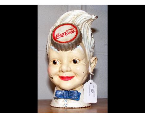 A vintage style cast iron Coca-Cola 'Sprite Boy' soda head coin bank