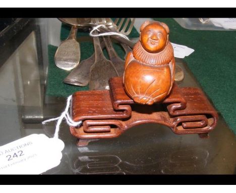 A carved wooden Netsuke on standCONDITION REPORTsignature as per images