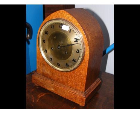 A lancet shaped oak mantel clock - 33cm high 