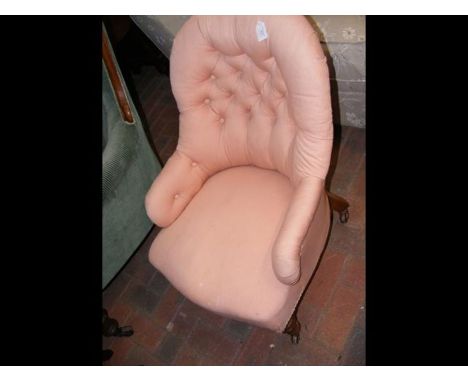 A pink button back nursing chair