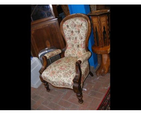 An antique button back armchair 