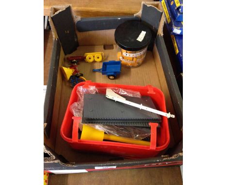 An unboxed Britains farm building with assorted Britains farm implements/tractor attachments.