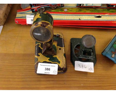 A vintage tinplate military searchlight with lightbulb and a diecast searchligh