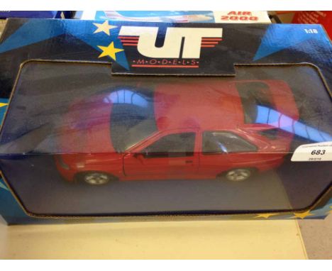 A boxed UT Models Red Ford Escort Cosworth 1:18 scale