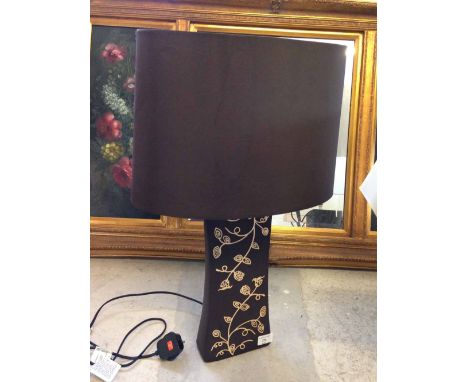 A designer table lamp with brown pedestal decorated with cream leaves & brown shade.