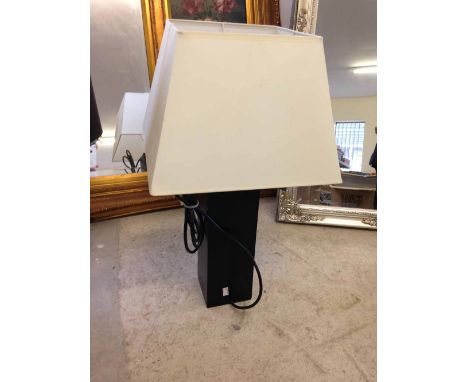 A designer table lamp by Aimbry, black pedestal and cream shade.