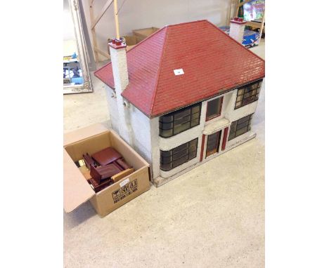A vintage dolls house with Deco style curved windows, with assorted furniture - dated Christmas 1948