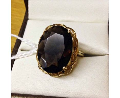 9ct gold ring set with very large oval smokey quartz stone in a pierced mount. Size R½.