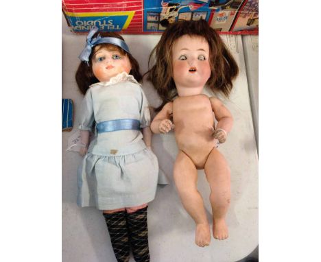 A German bisque head doll marked PM 23 Germany 3, Porzellonfabrik Mengersgereuth, brown glass open/shut glass eyes, composite