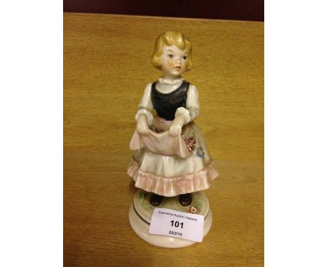 A Goebel figure of a girl with flowers in her apron.