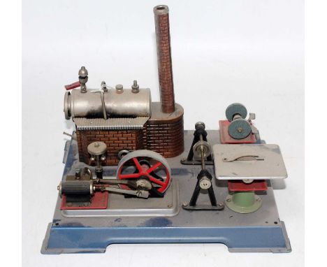 A Wilesco stationary steam plant comprising of tin housed horizontal boiler with steam and take off ports with burner powerin