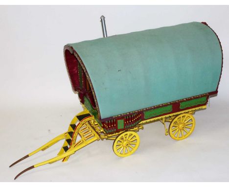 A very well made wooden and metal constructed model of a travelling caravan, approximately 2 inch scale, of 4 wheel construct