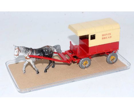 A Charbens 1950s repainted model of a lead horsedrawn Hovis Bread delivery cart comprising of red and cream body with yellow 