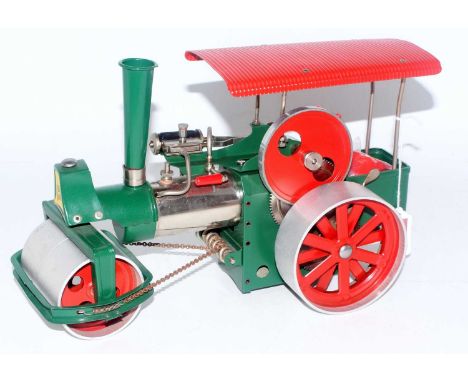 A Wilesco Old Smoky steam roller traction engine comprising of cream chrome and red body complete with funnel and burner, loo