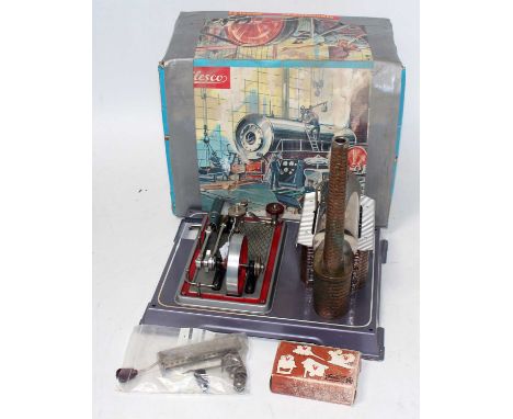 A Wilesco D16 stationary steam plant comprising of tin housed brickwork effect horizontal boiler powering a single cylinder e