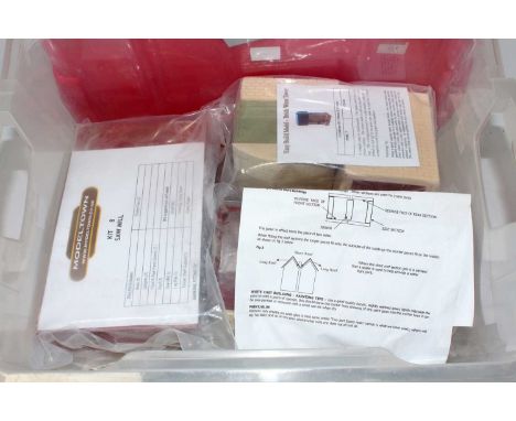 Plastic crate containing unassembled 'G' scale Modeltown kits:- no. 24 merchants house, no. 8 saw mill, no. 7 brick water tow