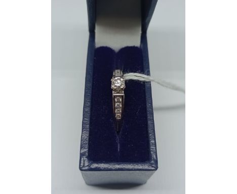 A white metal diamond ring, marked DIA 0.25 ct in associated box, size I/J, wt. 3.6g. 