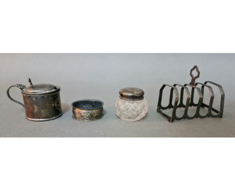 A collection of hallmarked items including toast rack, napkin ring, condiment pot and a silver topped cut glass pot, gross wt