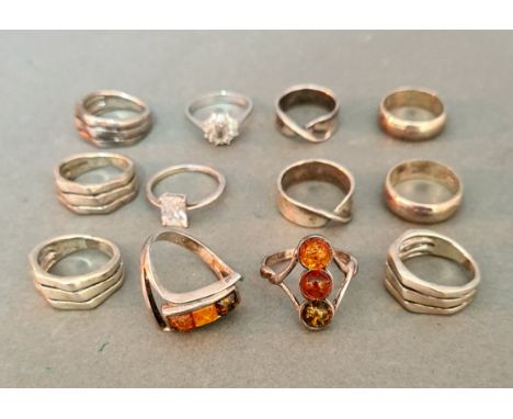 A group of 12 hallmarked silver rings to include two with amber cabochons, all marked 925, sizes K, L, M, N, P and R, gross w