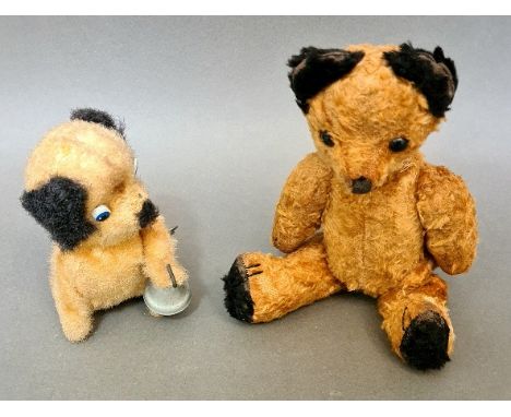 An early 20th century mohair teddy bear together with a 1960s vintage Ding Ding doggie tin wind up toy. 