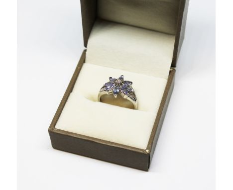 A tanzanite and diamond flower head ring, marked '14K', size M. 