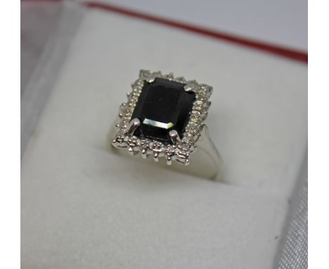 A hallmarked 9ct white gold diamond and sapphire ring, gross wt. 4g, size N. 