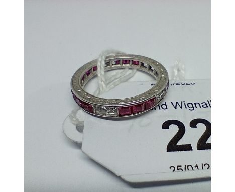 A synthetic ruby and sapphire full eternity ring, engraved outer edge, channel set princess cut stones, unmarked gross wt. 2.