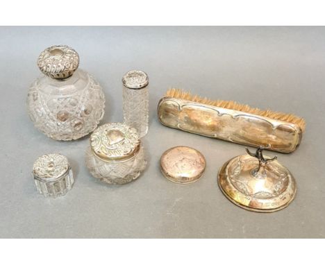 Assorted hallmarked silver comprising a brush, cut glass bottles, ring tree, etc. 