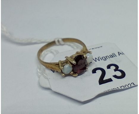 A hallmarked 9ct gold garnet and opal ring, size L/M, gross wt. 1.77g. 