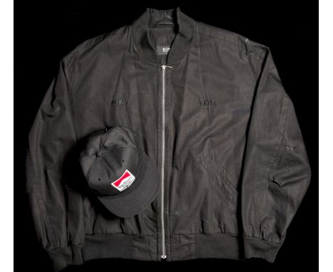 Murray Walker's Penske black silk jacket by Hugo Boss and Team Penske cap,
the name PENSKE embroidered in black silk upon the