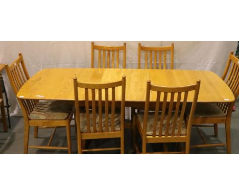 Ercol Windsor golden elm extending dining table with central folding leaf and a set of six stick back dining chairs, 200 x 92