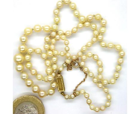 Early 20th century French single strand of graduated pearls with an 18ct gold clasp and 9ct gold safety chain, L: 52 cm. P&am