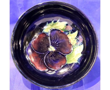 Small Moorcroft footed bowl, Blue ground in the Pansy pattern, D: 8 cm. Light crazing otherwise no cracks, chips or visible r