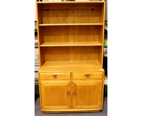 Ercol Windsor light elm bookcase cabinet of two shelves, two drawers and two cupboard doors, 91 x 43 x 160 cm H. Not availabl
