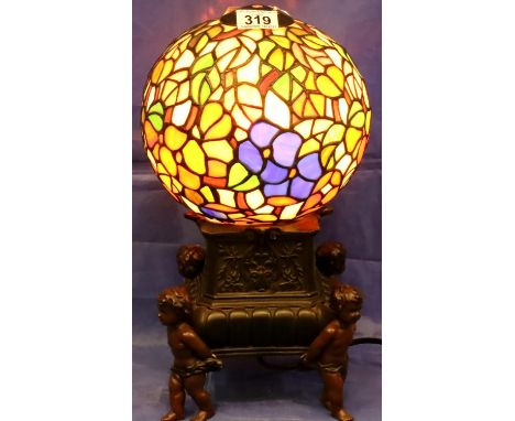 A modern table lamp with globular coloured glass shade, raised on a figural bronzed support, H: 38 cm. Not available for in-h