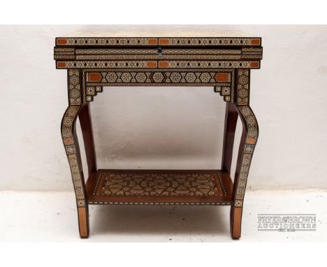 An Middle Eastern games table, the micro-mosaic table inlaid in various woods and mother of pearl with intricate geometric pa