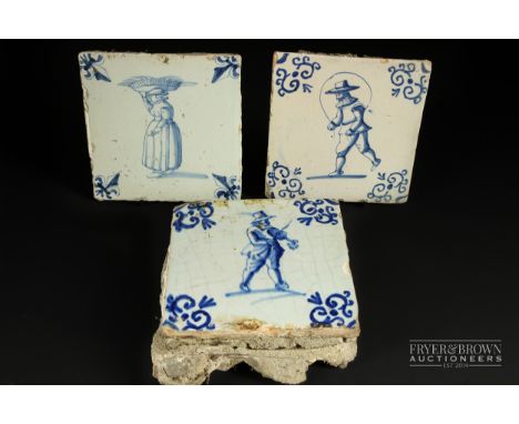 Three 17th/18th century Delft blue & white pottery tiles, including a woman carrying a basket on her head, a man skipping, an