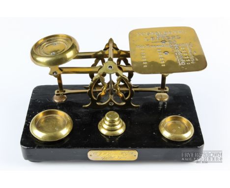 A set of brass and ebonised wood postal scales, with presentation plate dated 1901, 22.5cm max.