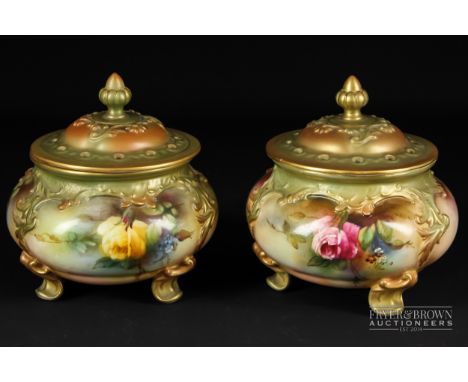 A pair of Royal Worcester potpourri vases & covers, of squat cauldron form, each on four scroll volute feet, painted with red