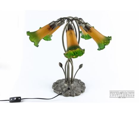 A spelter table lamp in Art Nouveau style, modelled as stylised flowers, five arms with frosted glass shades graduated ochre 