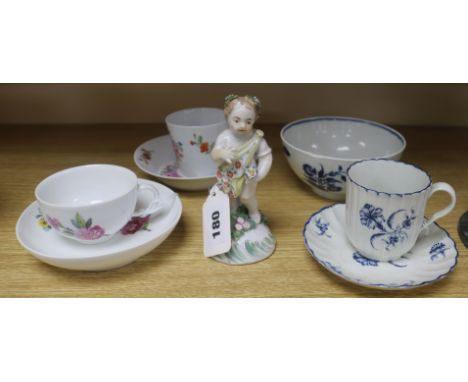 A Derby putto, a Worcester cup and saucer, a Berlin cup and saucer and three other items