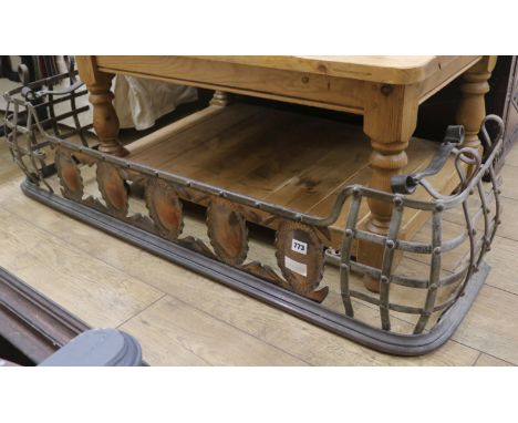 An Arts & Crafts wrought iron and copper fender, W.127cm