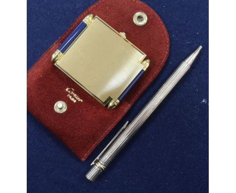 A Cartier pen and a Cartier travelling clock